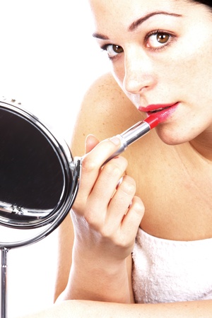 Young Woman Applying Red Lipstickの写真素材