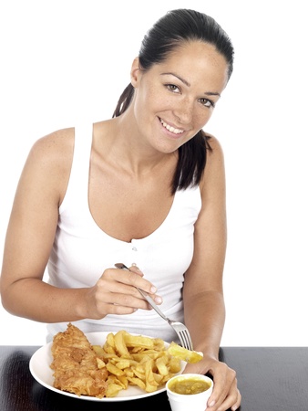 Young Woman Eating Fish and Chipsの写真素材