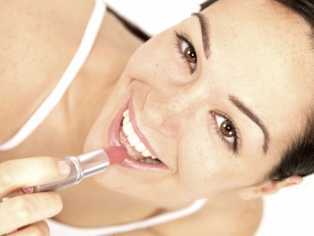 Young Woman Applying Lipstickの写真素材