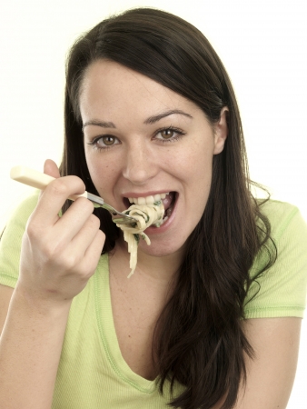 Young Woman Eating Prawn Linguineの写真素材