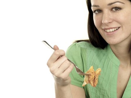 Young Woman Eating Pasta Bakeの写真素材