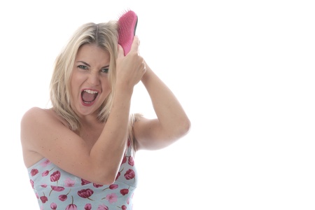 Model Released. Attractive Young Woman Brushing Tangled Hairの写真素材