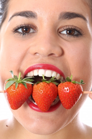 Young Woman Eating Strawberriesの写真素材