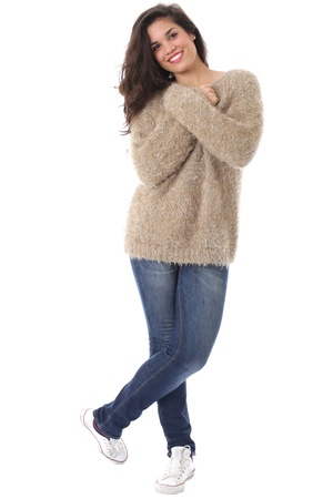 Model Released. Happy Smiling Young Woman Wearing Jeans and a Woolen Jumperの写真素材