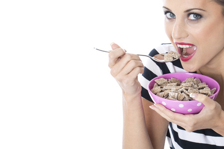 Model Released. Attractive Young Woman Eating Breakfast Cereal