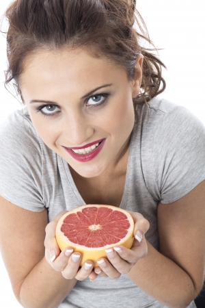 Model Released. Attractive Young Woman Holding Pink Grapefruitの写真素材