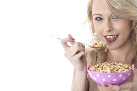 Model Released. Attractive Young Woman Eating Breakfast Cerealsの写真素材