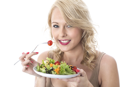 Model Released. Attractive Young Woman Eating Saladの写真素材