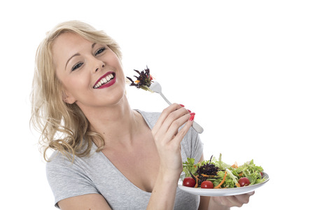 Model Released. Attractive Young Woman Eating Saladの写真素材