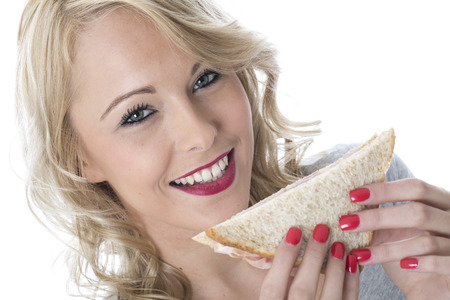 Model Released. Attractive Young Woman Eating a Sandwichの写真素材