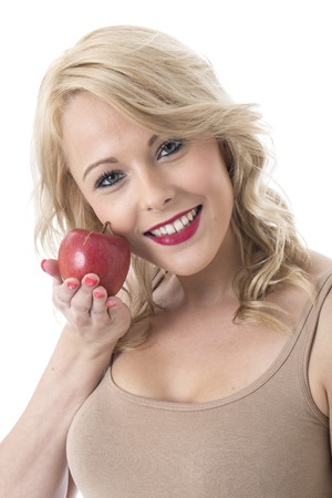 Model Released. Attractive Young Woman Holding a Red Appleの写真素材