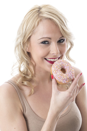 Model Released. Attractive Young Woman with Iced Donutsの写真素材