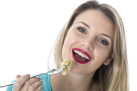  Attractive Young Woman Eating Spinach and Pine Nut Pasta