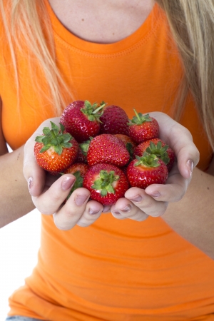  Attractive Young Woman Holding a Handful of Strawberriesの写真素材