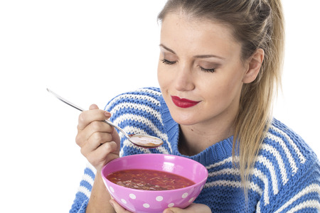  Attractive Young Woman Eating Minestrone Soupの写真素材
