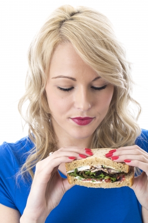 Model Released. Attractive Young Woman Eating a Sandwichの写真素材