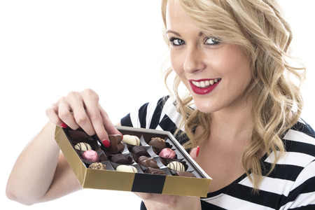 Model Released. Attractive Young Woman Eating Chocolatesの写真素材