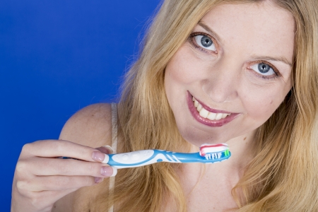 Model Released. Happy Young Woman Brushing Teethの写真素材