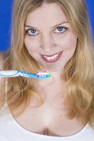 Model Released. Happy Young Woman Brushing Teethの写真素材