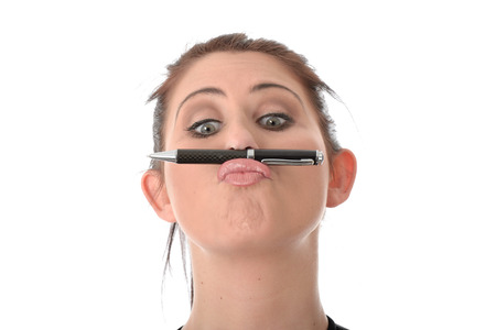 Young Woman Holding a Pen on her Lipsの写真素材