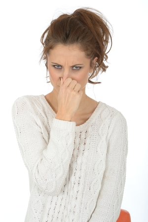 Young Woman Holding Noseの写真素材