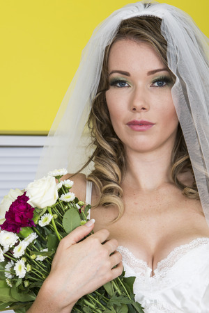 Beautiful Young Wedding Bride Carrying Flowersの写真素材
