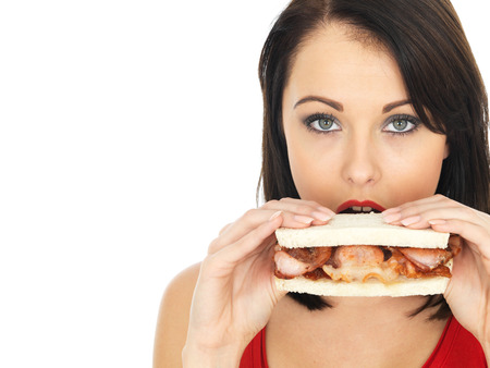 Attractive Young Woman Eating a Bacon Sandwichの写真素材