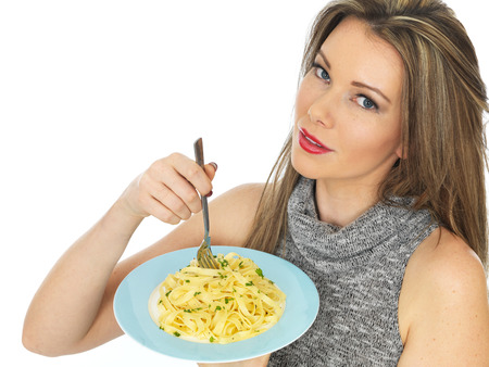 Attractive Young Woman Eating Tagliatelle Pastaの写真素材