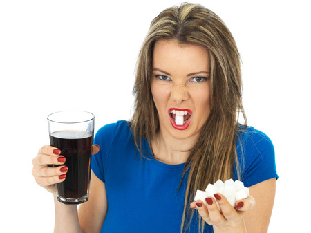 Attractive Young Woman Drinking High Sugar Fizzy Drinkの写真素材