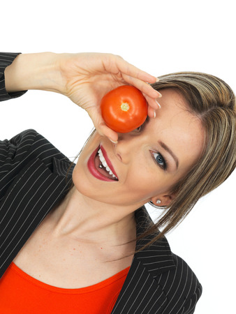 Young Healthy Business Woman Holding a Raw Tomatoの写真素材