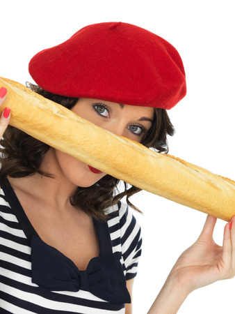 Attractive Happy Young Woman Eating a French Stick Bread Loafの写真素材