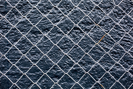 Wire Fence Tight Against A Black Backgroundの写真素材