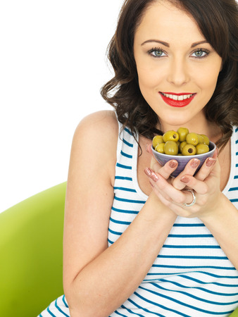 Young Healthy Woman Eating Green Olivesの写真素材
