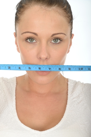 Healthy Young Woman Holding a Coloured Cloth Tape Measureの写真素材
