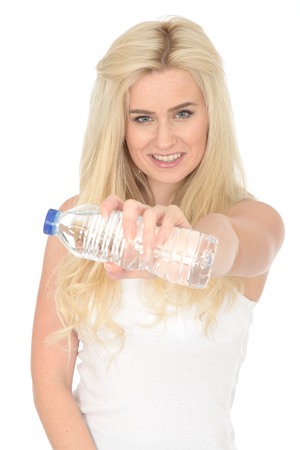 Fit Healthy Sexy Young Blonde Woman in Her Twenties Holding a Bottle of Mineral Waterの写真素材