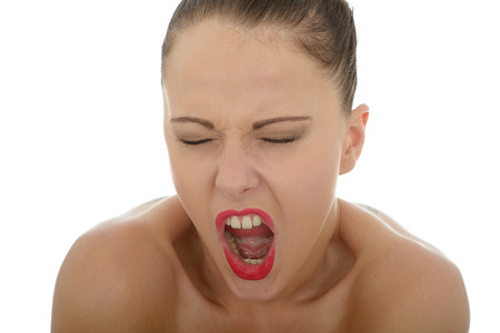 Portrait Of A Young Attractive Caucasian Woman In Her Twenties Screaming In Anger And Temper Shot Against A White Backgroundの写真素材