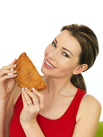 Attractive Young Woman Holding a Cooked Cornish Pasty Savory Snackの写真素材