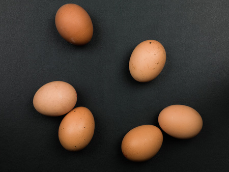 Six Fresh Uncooked Brown Eggs