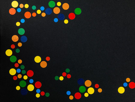 Coloured Dots Creating a Pattern on a Black Backgroundの写真素材