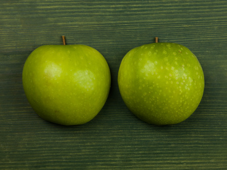 Fresh Healthy Ripe Apples on a Green Backgroundの写真素材