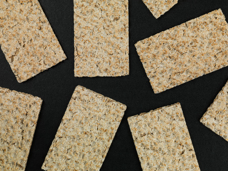 Crispy Dry Rye Crackers On A Black Backgroundの写真素材