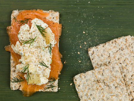 Smoked Salmon With Potato Salad and Dill on Rye Crispbreadの写真素材