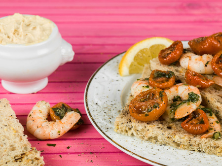 King Prawn and Cherry Tomato Open Sandwich Against a Pink Backgroundの写真素材