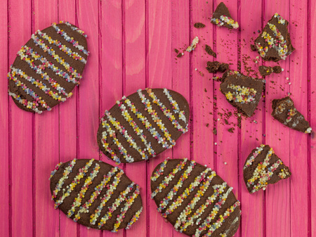 Decorated Novelty Chocolate Easter Biscuits Against a Pink Background