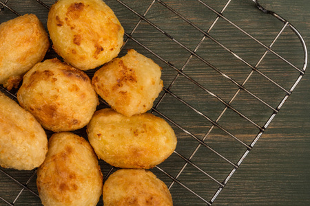 Roast Potatoes on a Steel Kitchen Cooling Rack On A Green Wooden Background
