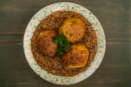 Minced Beef and Onions With Dumplings or Cobblers Meal On A Green Wooden Background With Copy Spaceの写真素材