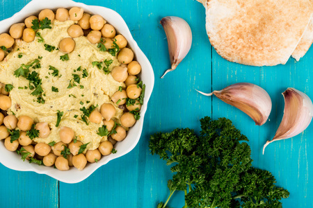 Hummus With Chickpeas and Pitta Bread On A Blue Wooden Backgroundの写真素材