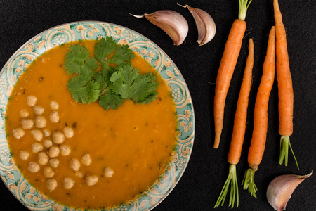 Bowl of Carrot and Coriander Soup On A Black Backgroundの写真素材