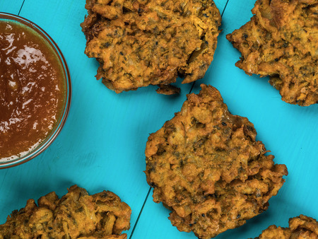 Onion Bhajis With Mango Chutney Against a Blue Background Against a Blue Background