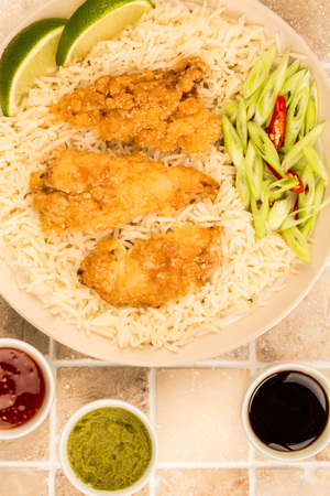 Japanese Style Deep Fried Chicken Tempura With Rice On A Tiled Kitchen Worktop or Counterの写真素材